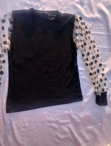Chic Black Top with Polka Dot Sleeves