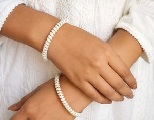 Gold wire between White Spiral Bangles .