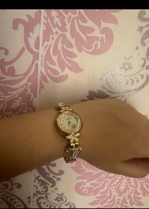 Elegant Gold Tone Watch with Charm