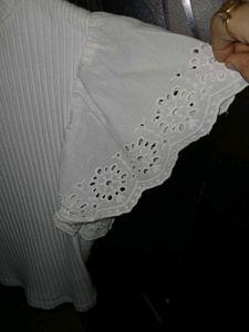 White ribbed crop top with flare sleeves.