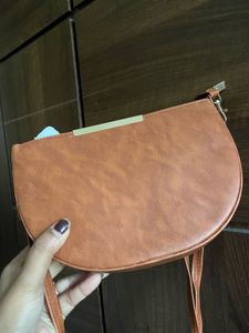 Tan brown half moon sling bag