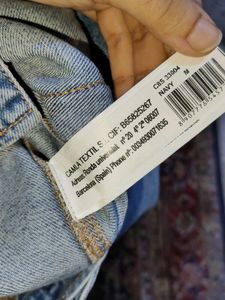 Distressed Denim Jacket with Pink Lace-Up Detail