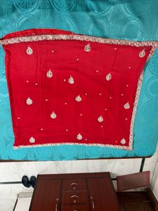 Vibrant Red Saree with Intricate Embellishments