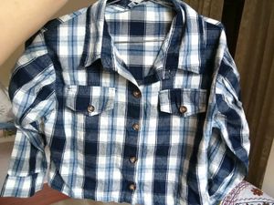 Blue Plaid Button-Up Shirt with ruffled sleeves.