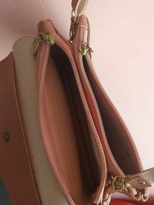 Peach Colour Sling Bag With 2 zips Can Carry Mobile ,wallet Cards And Make Up Items.