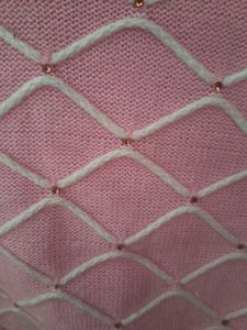 cute pink woole  top with white design and stones