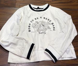bebe Long Sleeve Graphic Crop Top