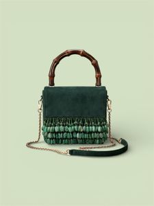 Elegant Green Suede Bag with Bamboo Handle