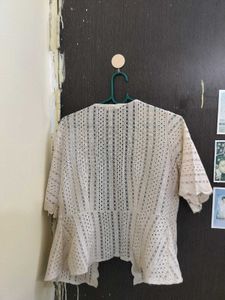 shrug in beige colour