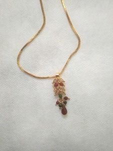 golden chain with ruby pendent