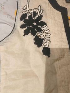 A contemporary short white kurta- no brand, worn o