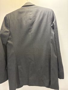 A crisp dark grey custom tailored suit