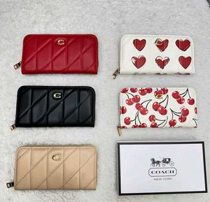 Coach Accordion Zip wallet featuring pillow quilti