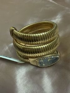 Elegant Gold Tone Coil Watch with Blue Dial