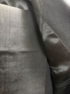 A crisp dark grey custom tailored suit