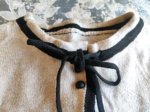 Chic Cream Knit Cardigan with Black Trim