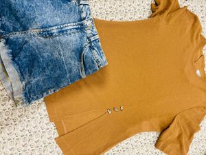 a short-sleeve top paired with blue denim short