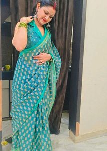 Elegant Teal Saree with Intricate Gold Patterns