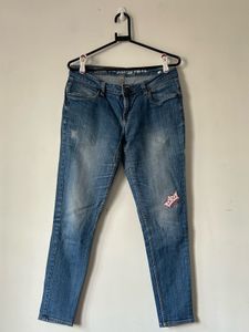 Women's Blue Distressed Jeans with Patch