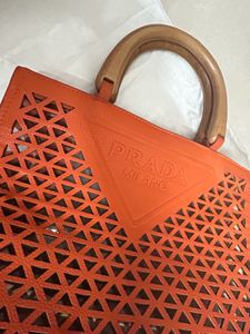 An orange Prada Bag