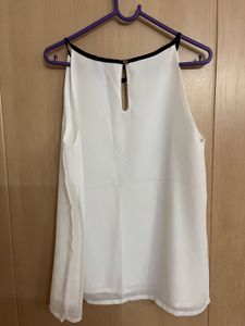 Chic White Sleeveless Top with Black Trim