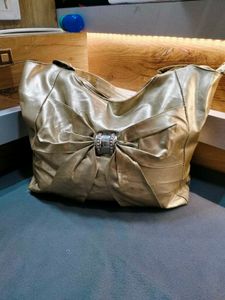 chic gold tote bag with bow accent