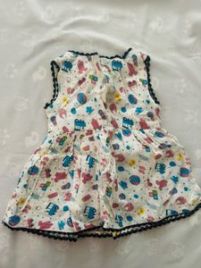 infant's white sleeveless cotton muslin frock