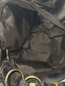 Stylish Black Textured Bag with Gold Emblem
