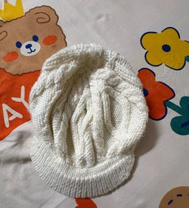 creamy-white knit,  textured cable pattern