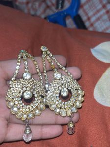 stylish indian earing with a pearl choker and ring