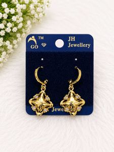 Elegant Gold Tone Star Earrings with Crystals