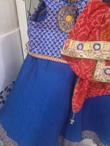 1) Royal Blue Lehenga Choli with Red Dupatta.  2)
