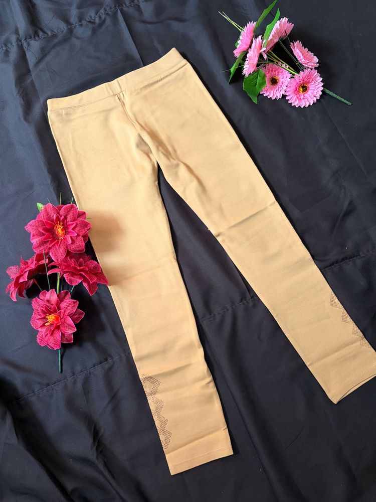 Elegant Beige Leggings with Embroidered Hem