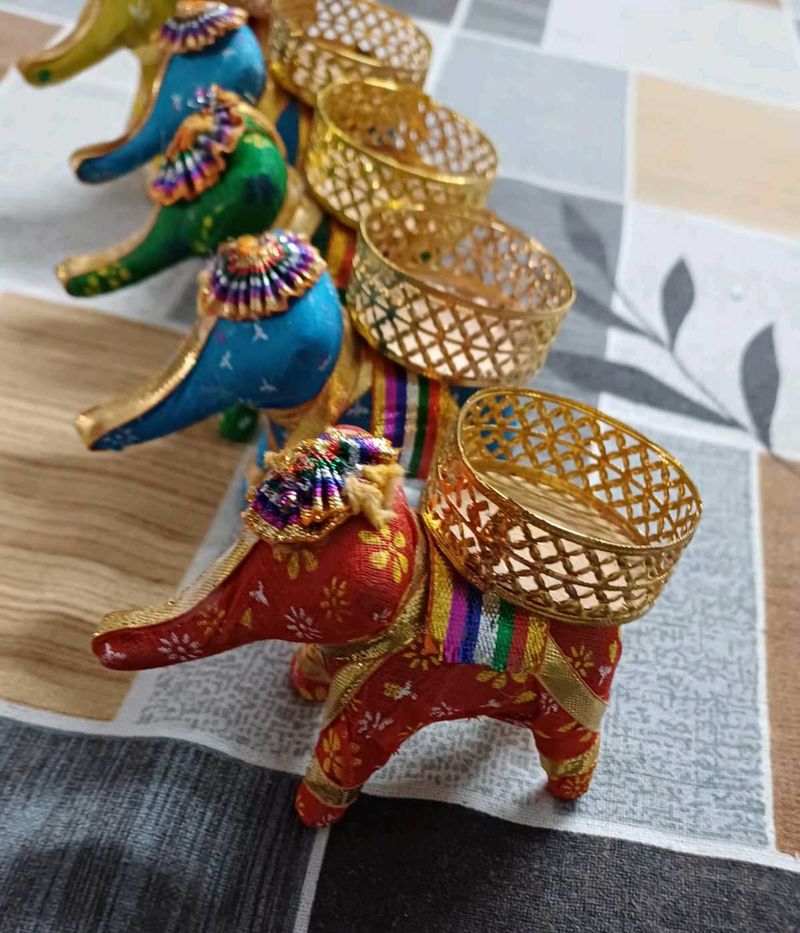 set of five elephants with diya on it