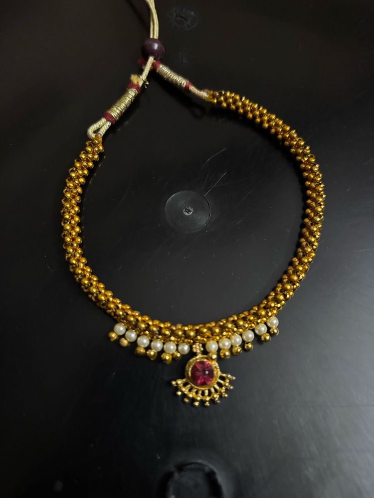 Elegant Gold Tone Necklace with Red Stone