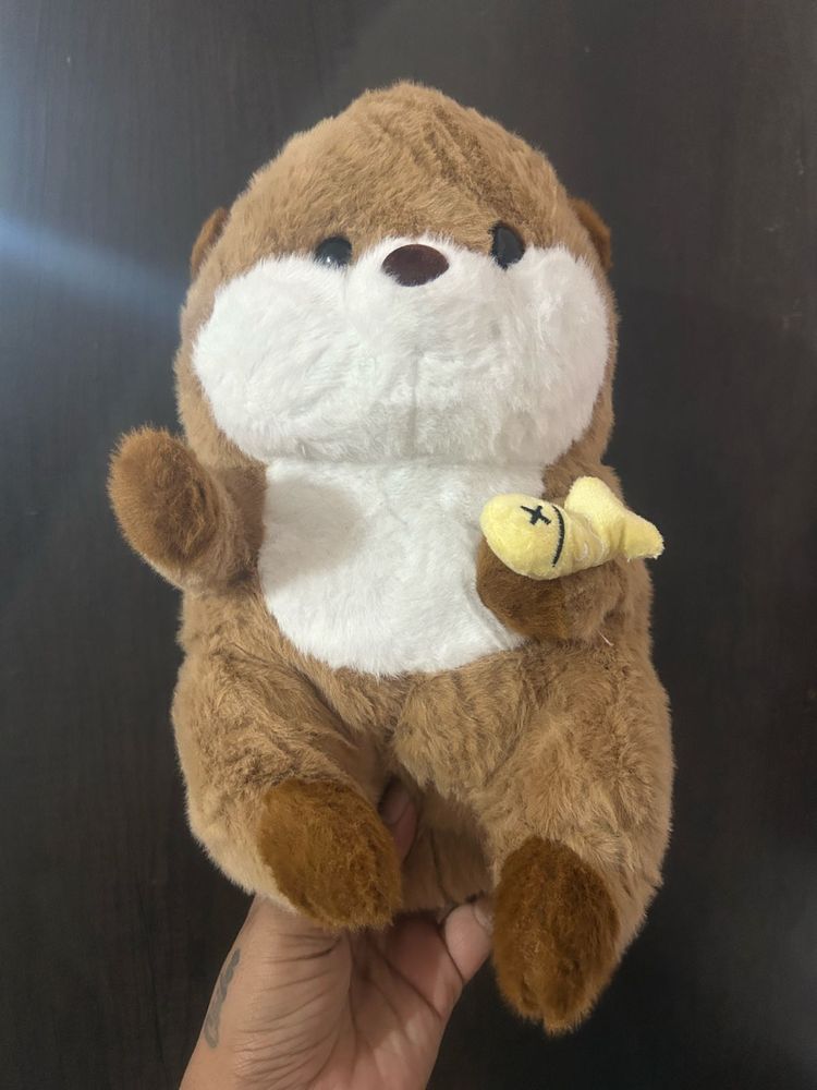 a brown cartoon otter holding tiny yellow fis