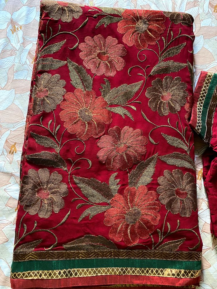 Maroon coloured Embroidered saree With Stitched blouse