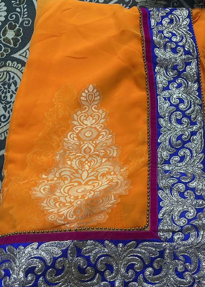Vibrant Orange Saree with Silver Embroidery