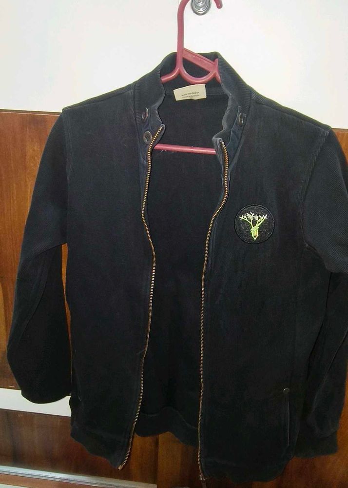 Classic Black Zip-Up Jacket with Unique Patch