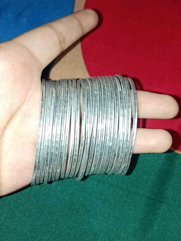 A dozen of silver metal bangles