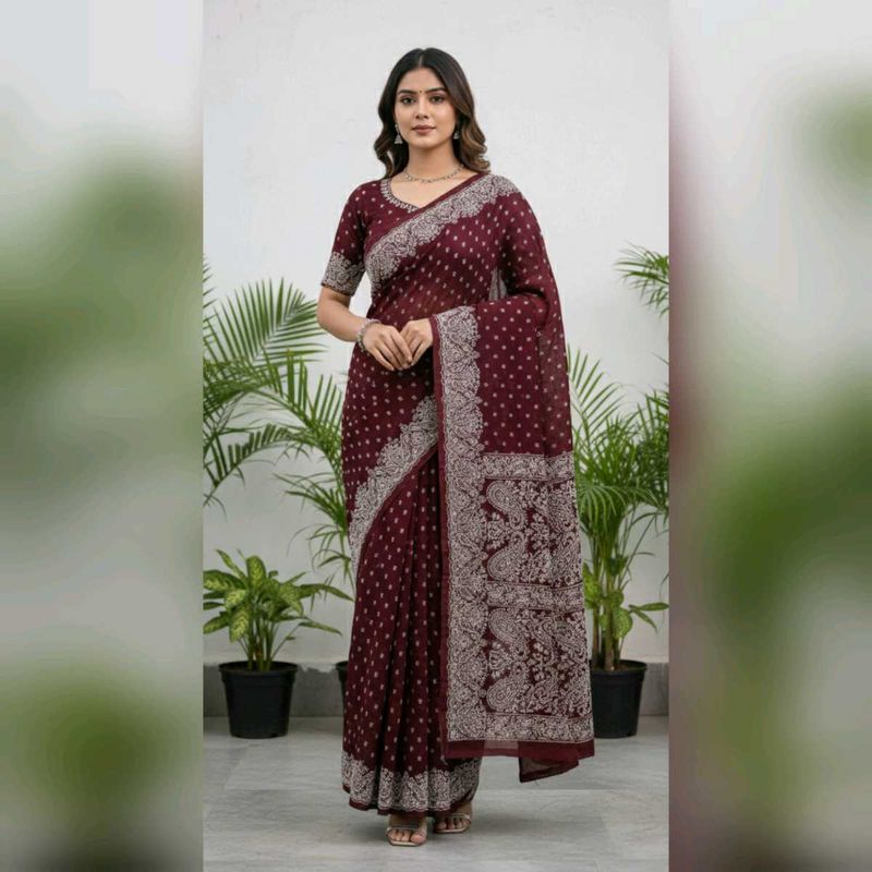 Burgundy saree having white design print.