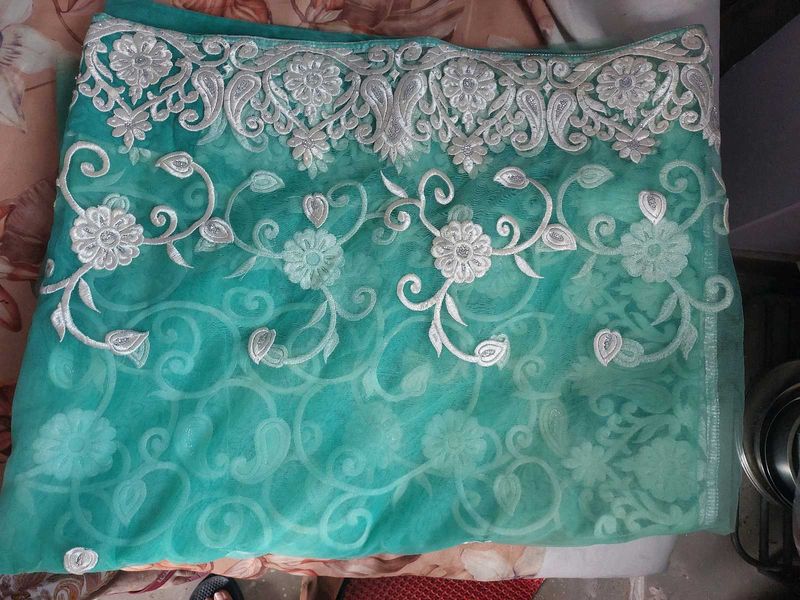 Elegant Embroidered Teal Net Saree