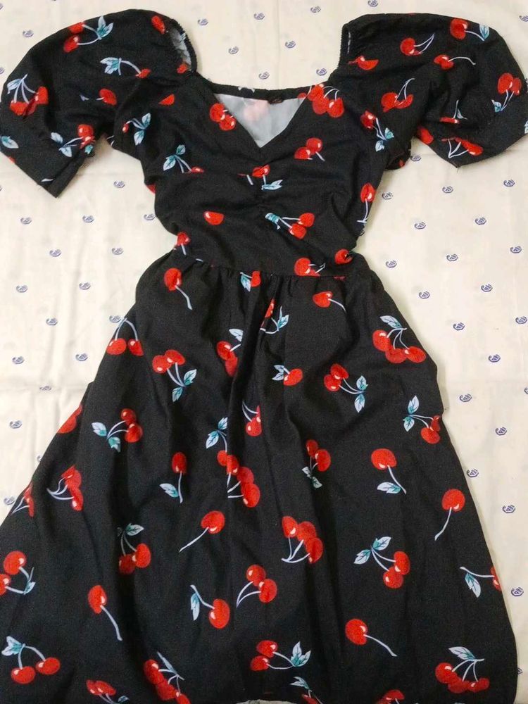 black mini dress with cherry patterns