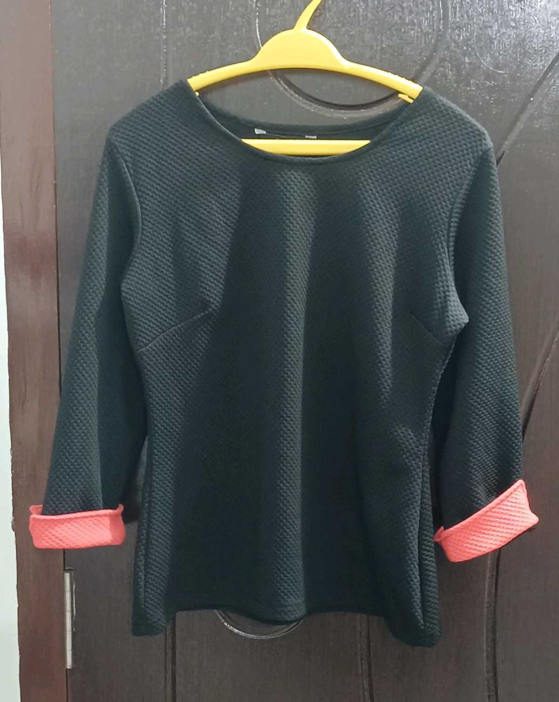 Chic Black Textured Top with Coral Cuffs
