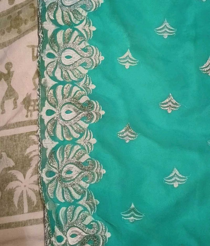 Elegant Teal Saree with Silver Embellishments