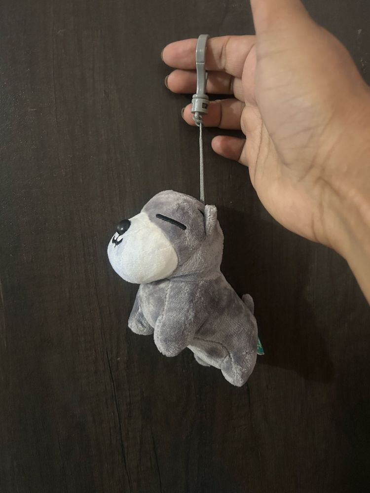 grey and white plush puppy keychain with closed