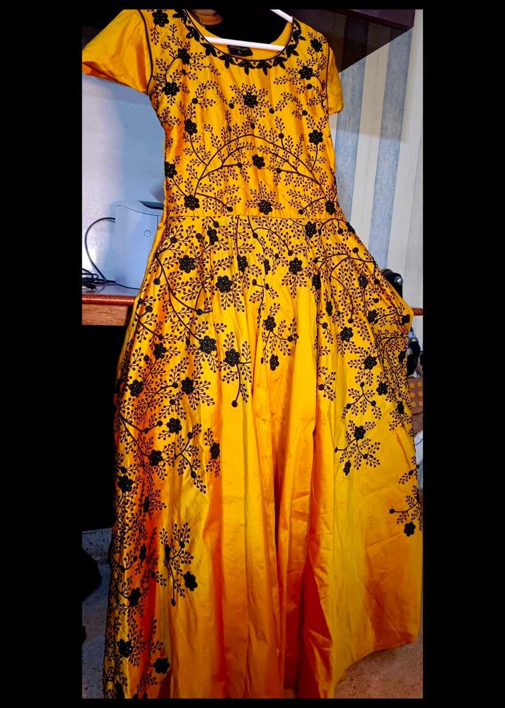 long yellow satin gown with black embroidery