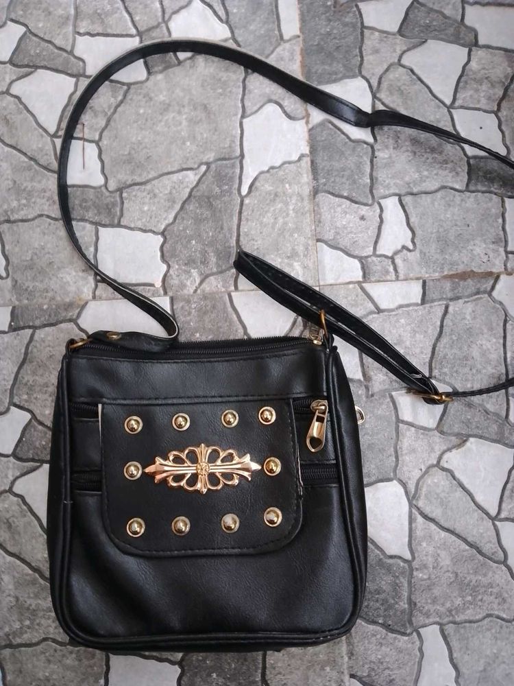 Stylish Black Crossbody Bag with Gold Accents