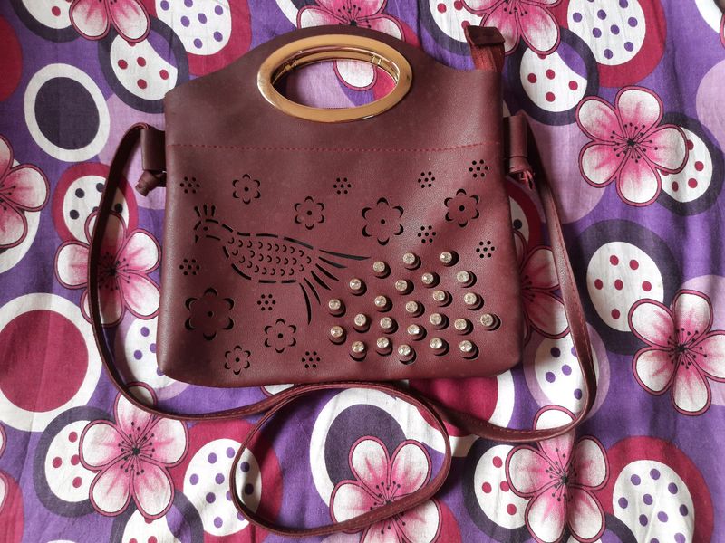 ladies maroon sling bag peacock laser cut