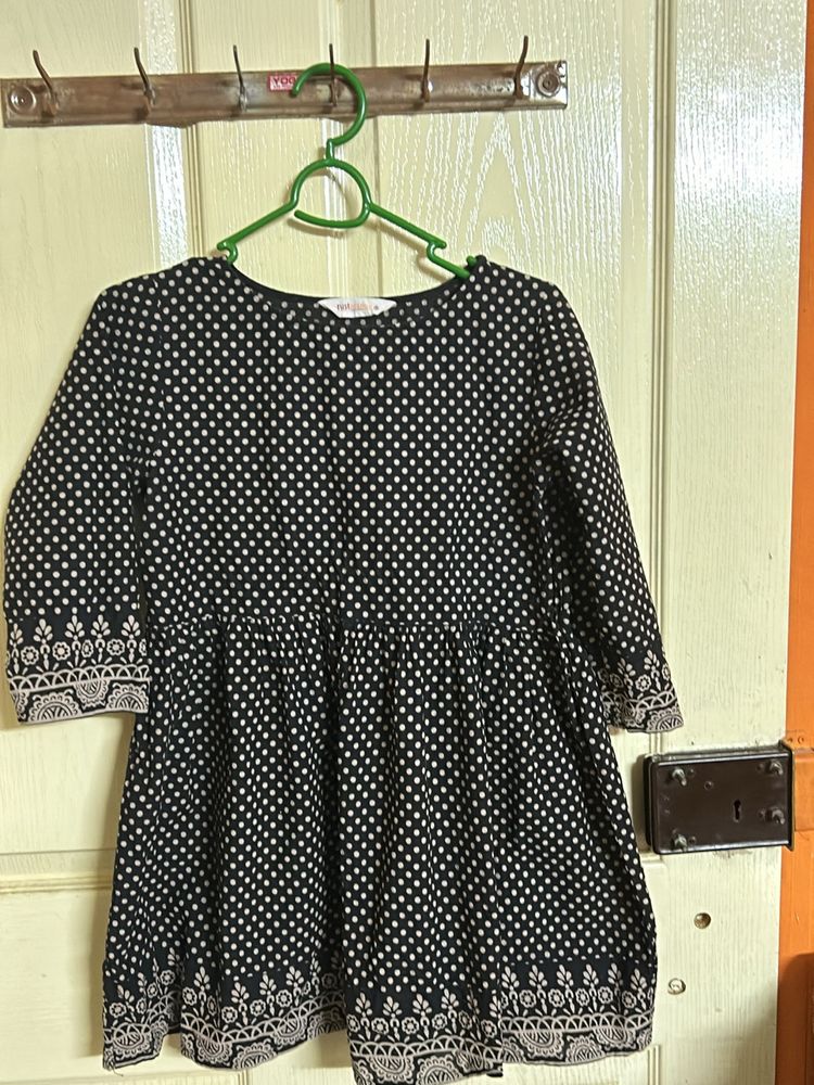A Black with Beige polka dots top
